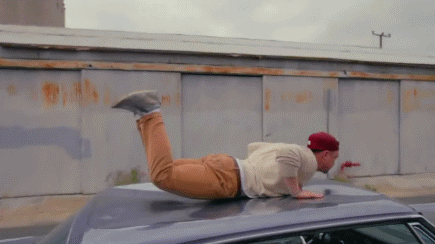 just_a_guy_doing_the_worm_on_top_of_a_moving_car-21275